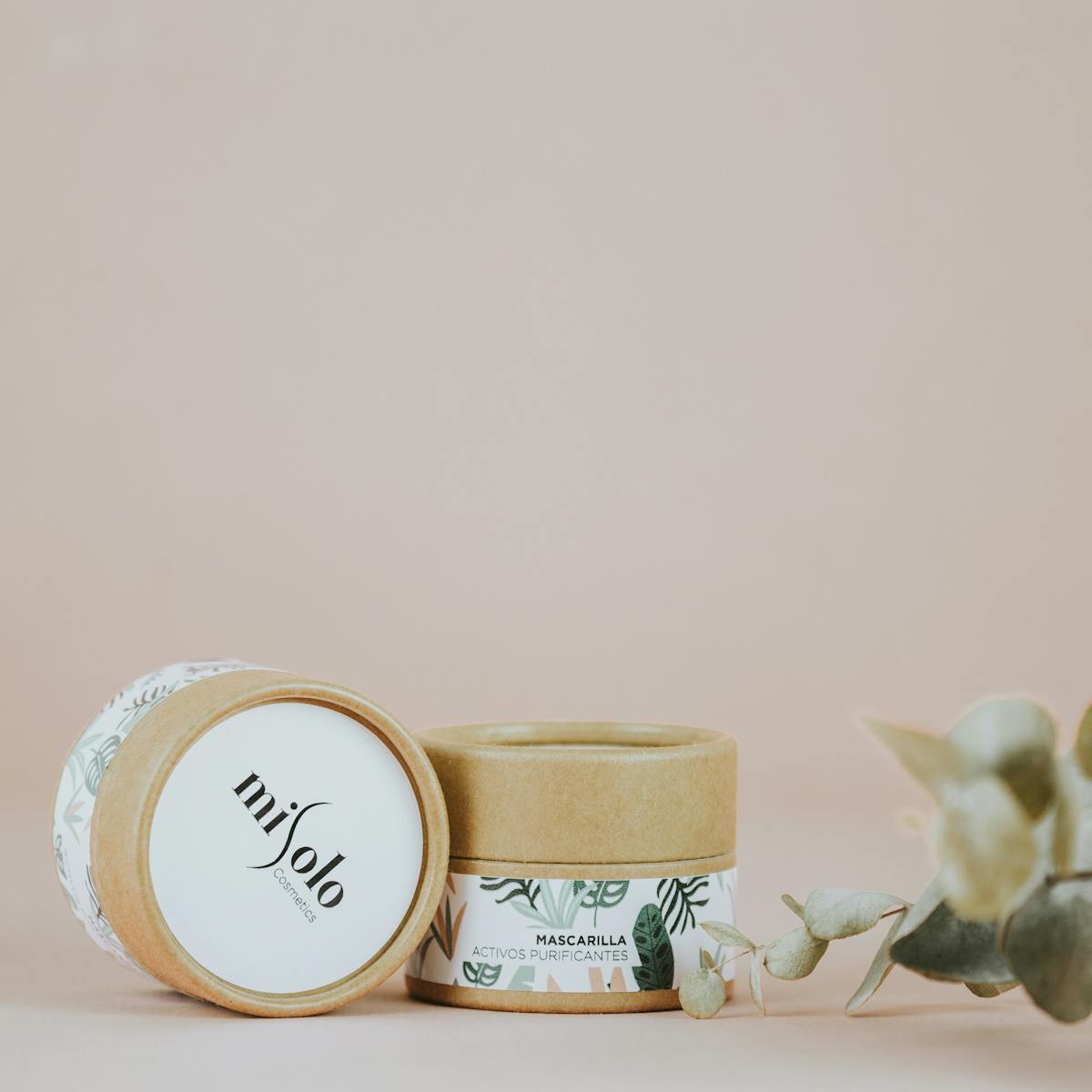 Stylish close-up of eco-friendly skincare products with natural elements.