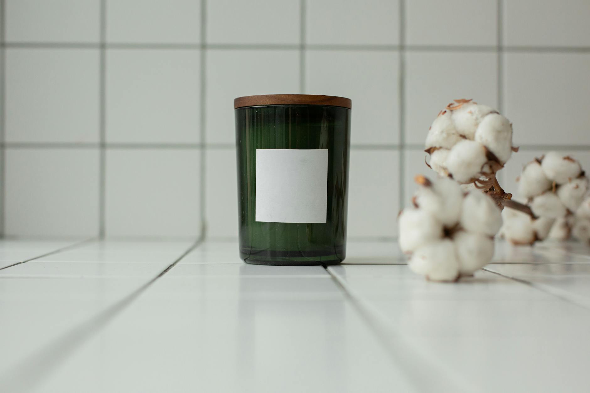 a glass container with a blank label