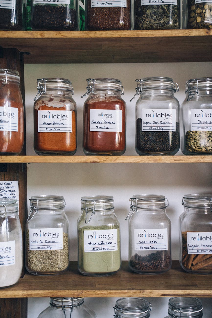 assorted glass jars on wooden shelf